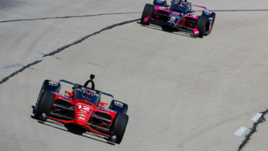 What does a black flag mean in IndyCar racing?